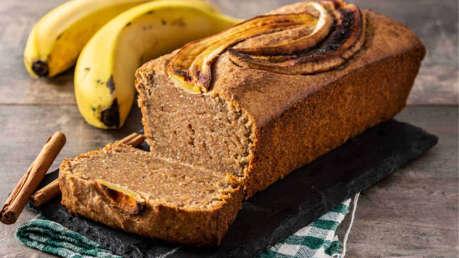 Homemade banana bread on rustic wooden table.