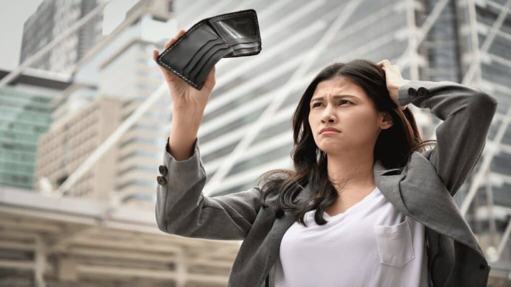 broke woman scratching head