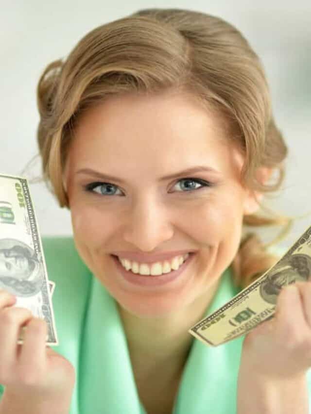 woman holding money in both hands