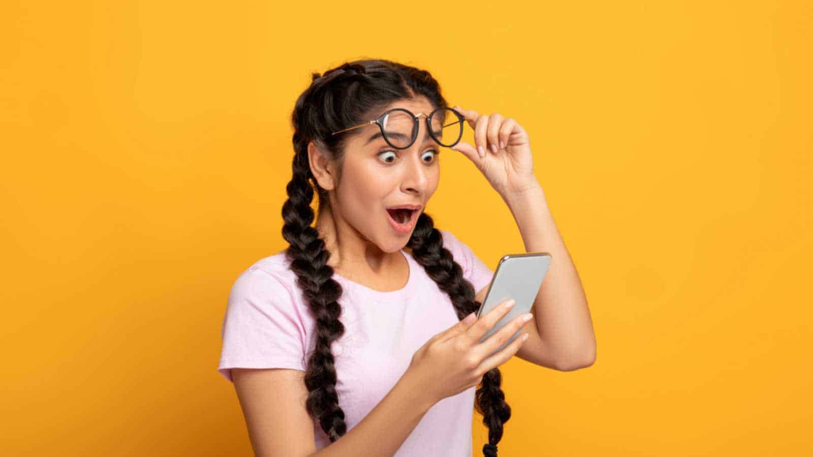 Excited woman with mobile
