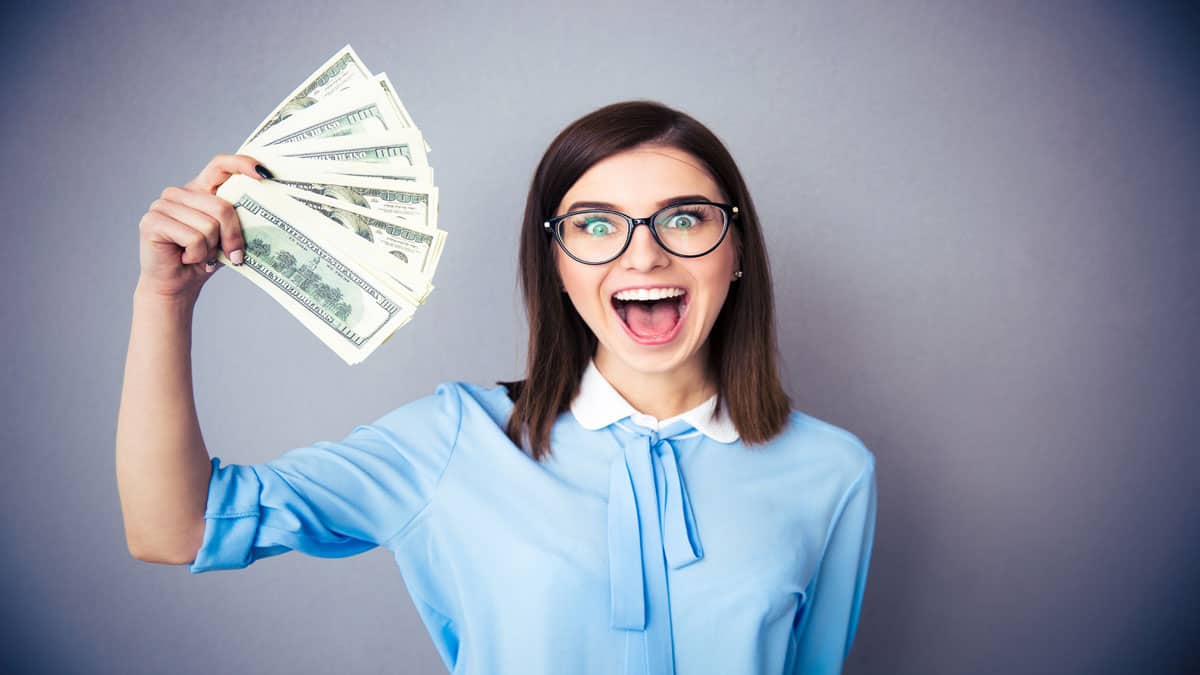 laughing woman holding money