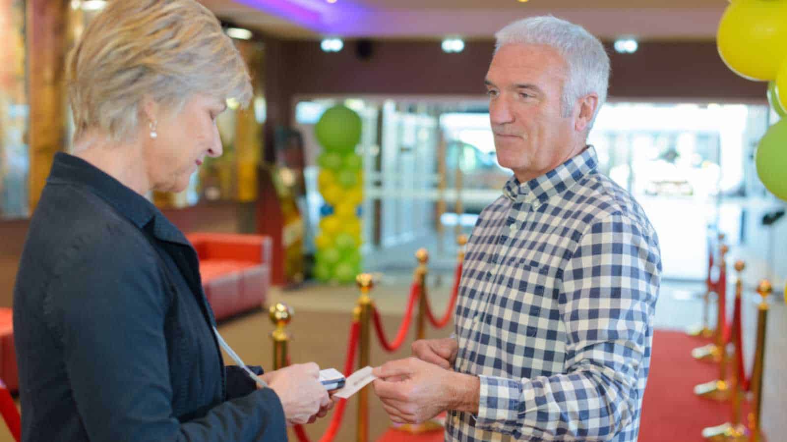 Man giving ticket to Woman
