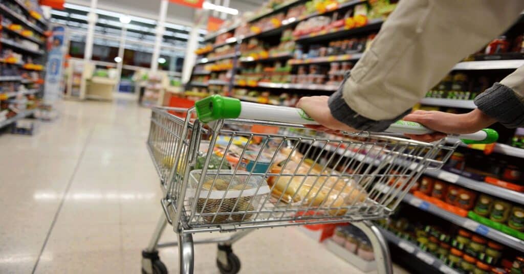 man pushing shopping cart