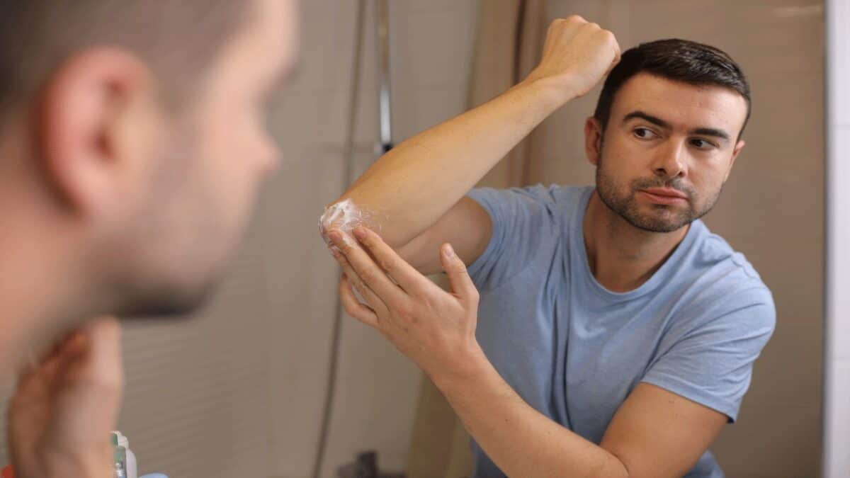 man-putting-cream-on