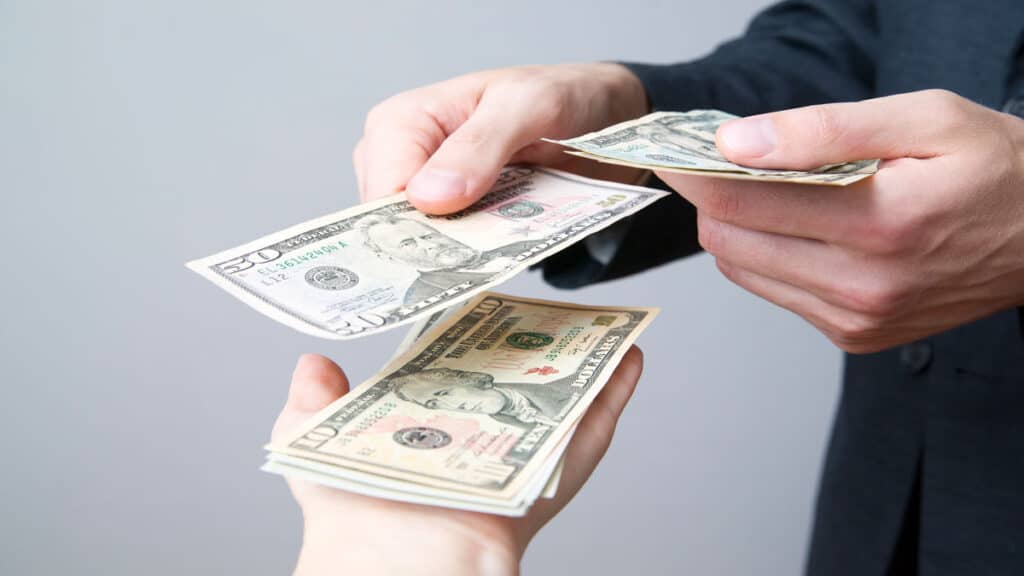 man paying money to someone