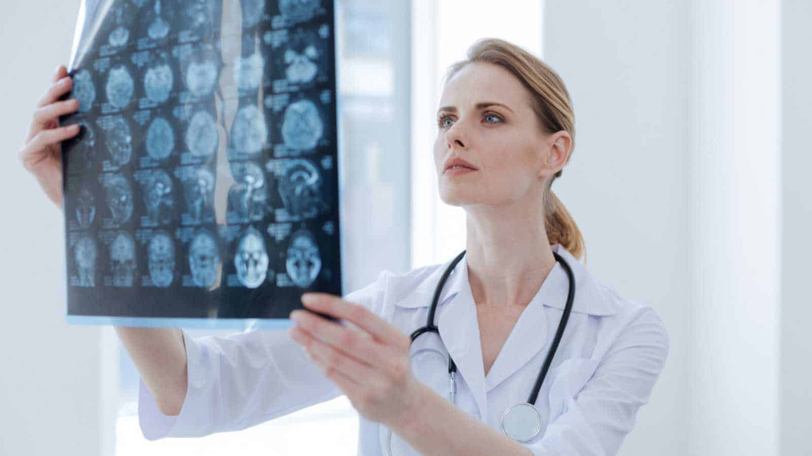 Attentive radiologist examining x ray at the clinic