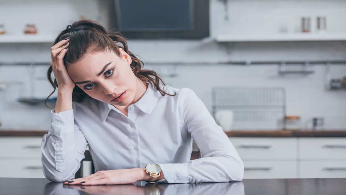 sad woman at table