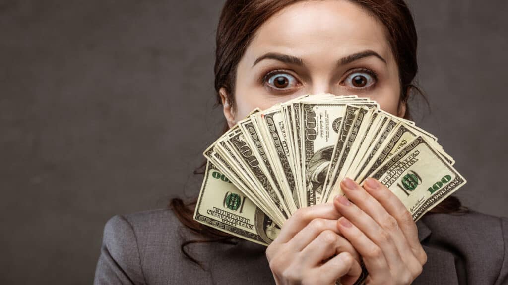 shocked woman with money