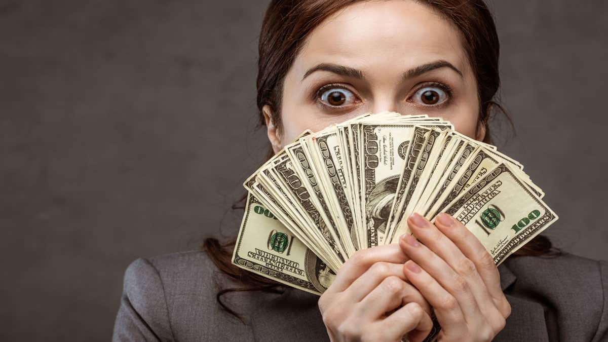 shocked woman with money