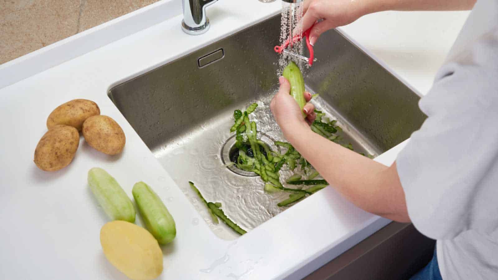 Food waste disposer machine in sink in modern kitchen