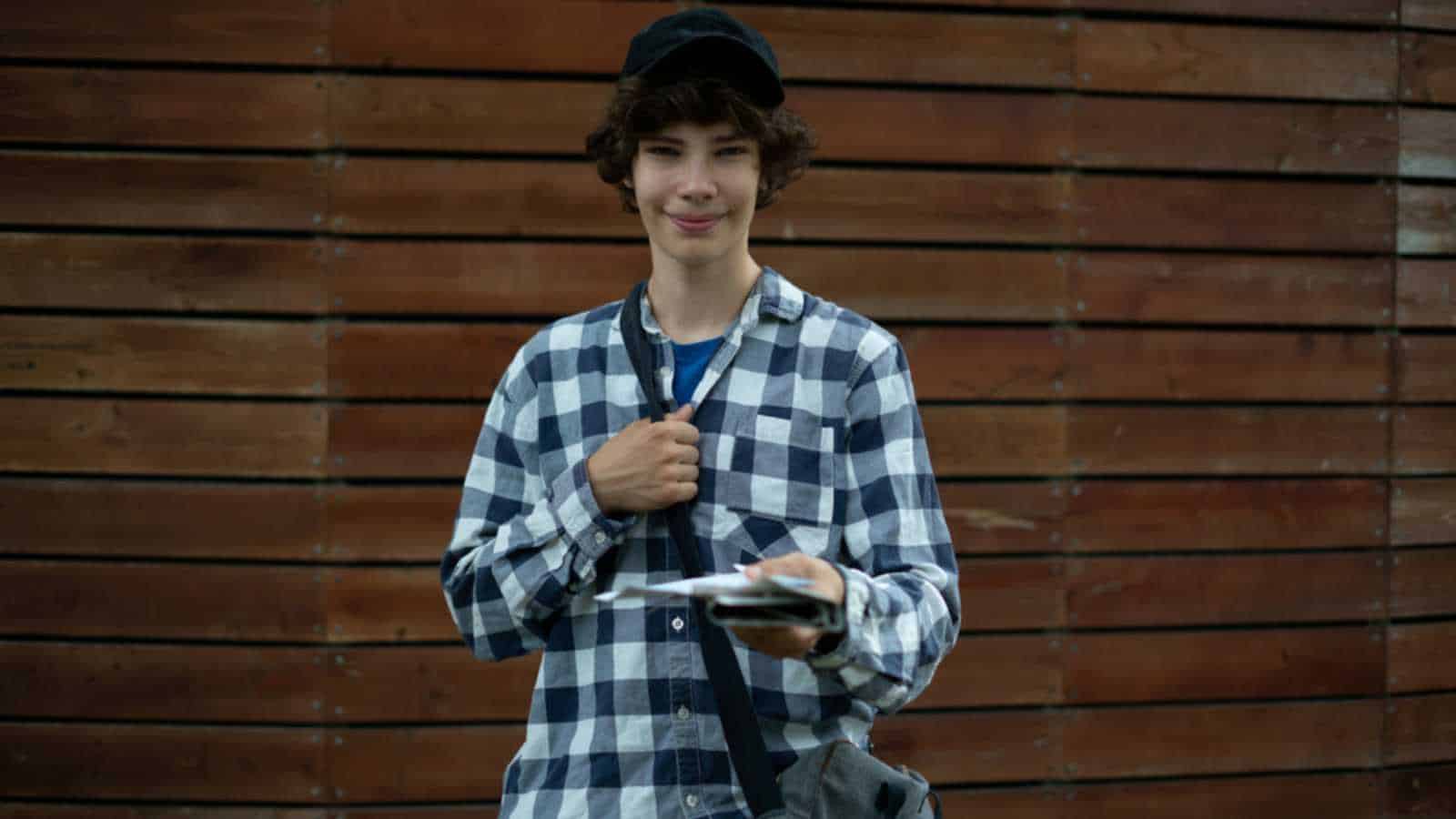 Teen delivering newspaper