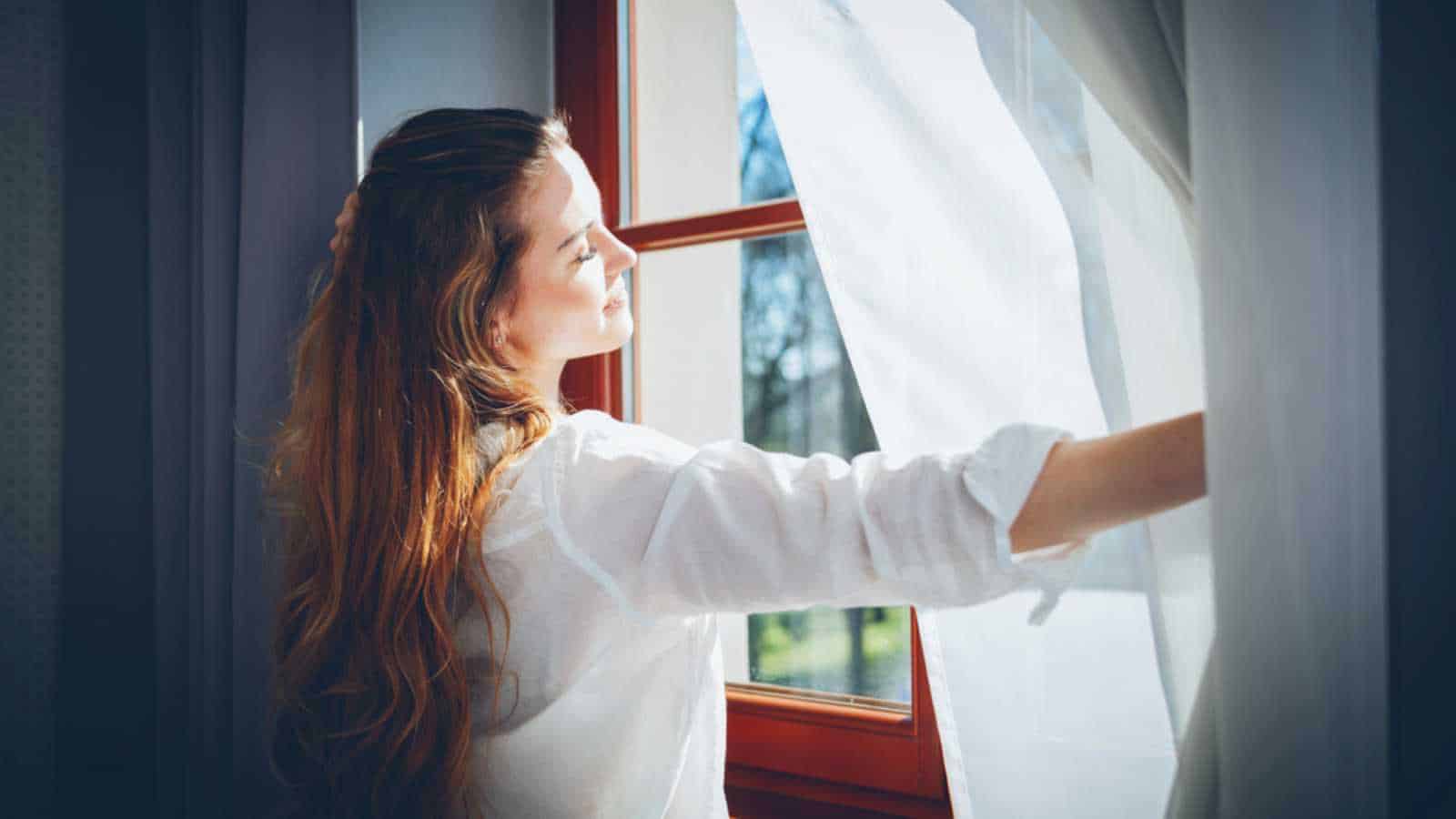 Woman opening window