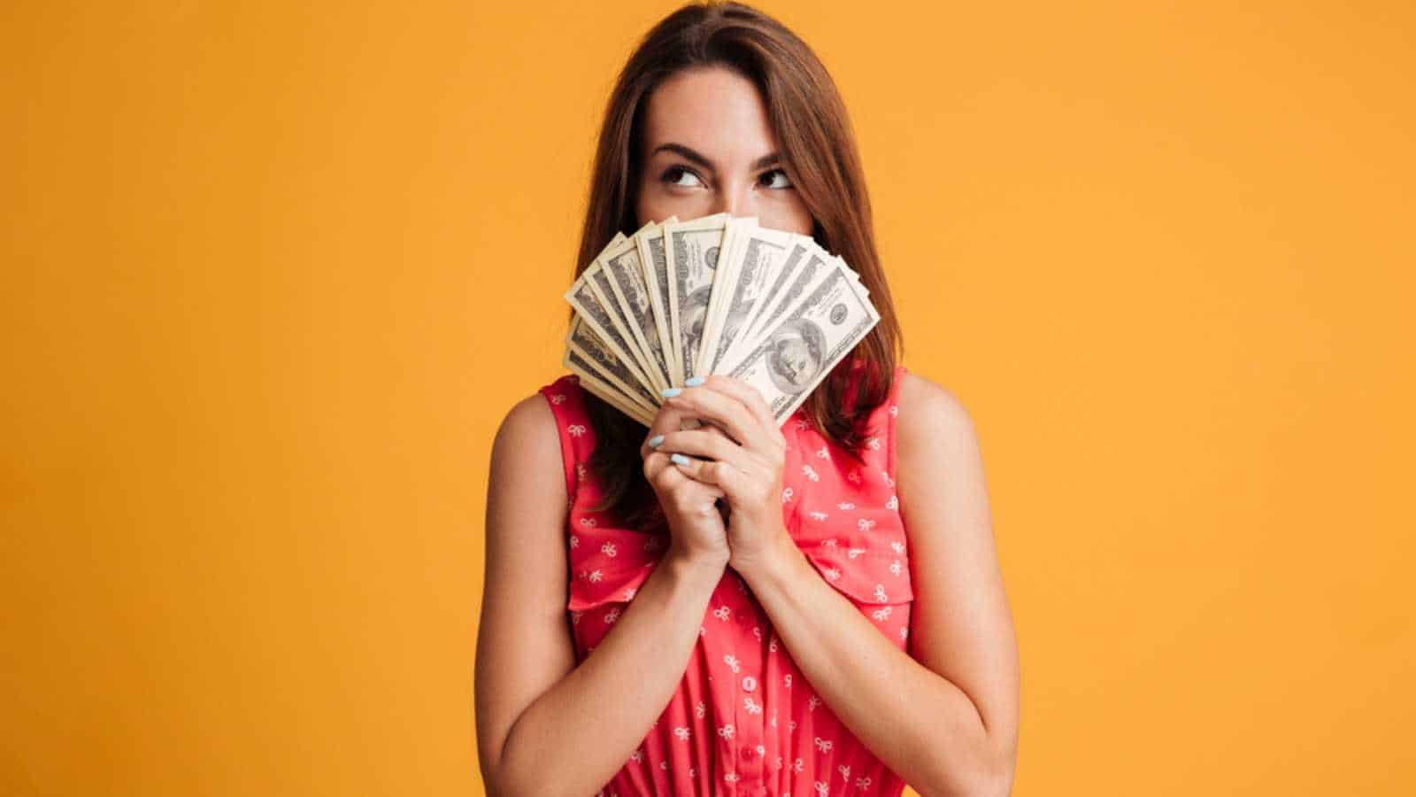 Woman with money thinking