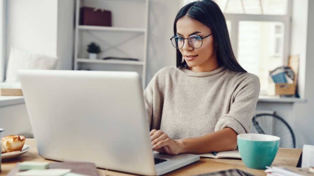 Woman working with cup of coffee