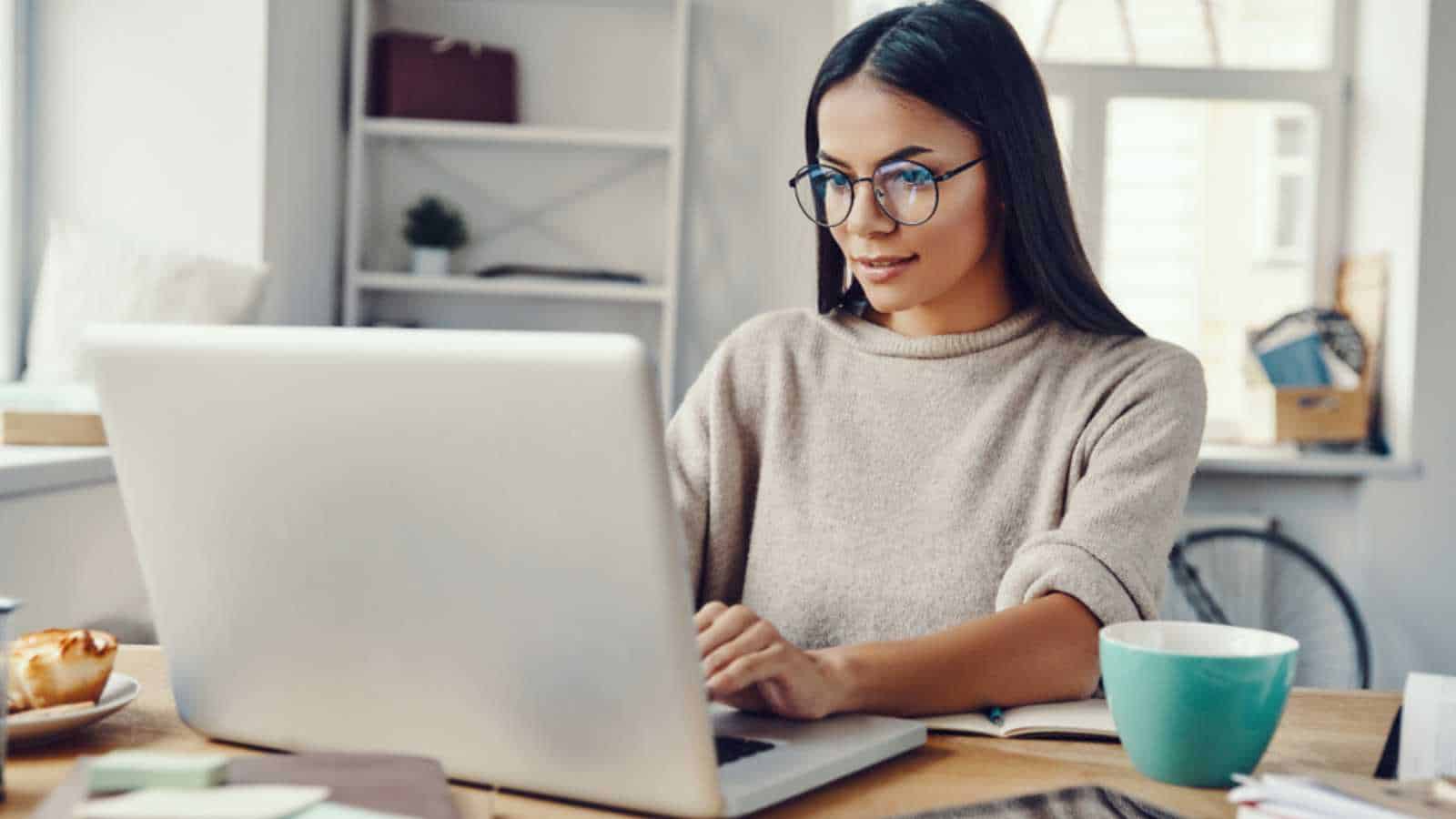 Woman working with cup of coffee