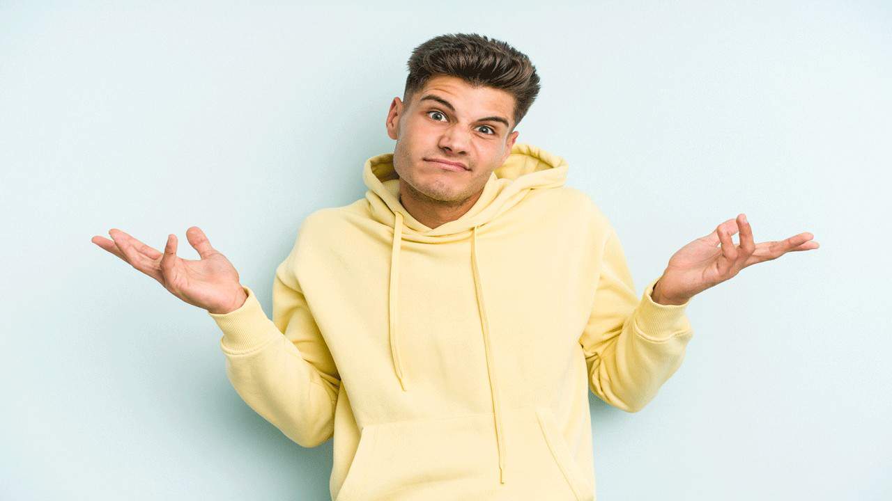 young man shrugging